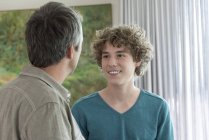 Happy father and son talking at home — Stock Photo
