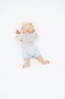 Blond baby boy crawling on white background — Stock Photo