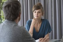 Young woman in meeting with adviser in office — Stock Photo