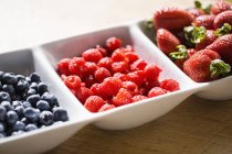 Assorted summer berries on white tray — Stock Photo