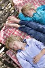 Tired little siblings sleeping in hammock in summer garden — Stock Photo
