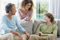 Happy family smiling in living room at home — Stock Photo