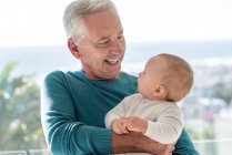 Happy grandfather with baby granddaughter — Stock Photo