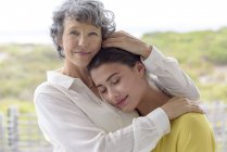 Loving mother hugging adult daughter outdoors — Stock Photo