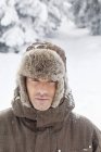 Jovem em roupas de inverno olhando para a câmera na natureza — Fotografia de Stock