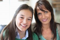 Portrait of a girl smiling with her mother — Stock Photo