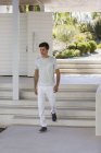 Young man walking downstairs outdoors — Stock Photo