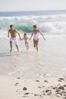 Family enjoying vacations on sandy beach — Stock Photo