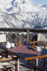 Breakfast table in a restaurant terrace, Courchevel, Alps, France — Stock Photo