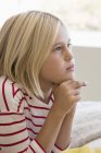 Close-up of thoughtful little girl looking away — Stock Photo