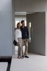 Couple standing at doorway of house and looking around — Stock Photo