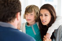 Boy with his parents discussing at home — Stock Photo
