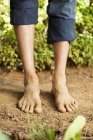Low section of barefooted man standing on ground — Stock Photo