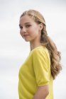 Портрет улыбающейся девочки-подростка в желтом свитере — стоковое фото