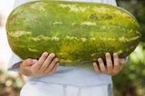 Close-up of boy holding ripe watermelon — Stock Photo