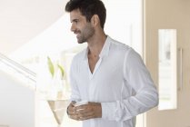 Happy man enjoying cup of coffee at home — Stock Photo
