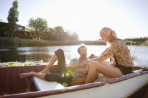 Young couple romancing in boat on lake in nature — Stock Photo