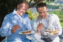 Two friends eating fruit salad — Stock Photo