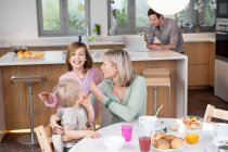 Family at a breakfast table — Stock Photo