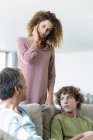 Multi-generation family talking in living room at home — Stock Photo