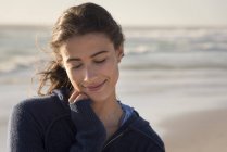 Happy dreamy young woman on beach — Stock Photo