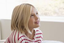 Close-up of blond little girl looking up — Stock Photo