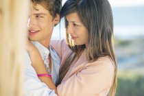 Close-up of embracing romantic young couple on beach — Stock Photo
