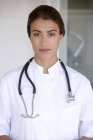 Portrait of confident female doctor standing and looking at camera — Stock Photo
