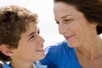 Woman and grandson looking at each other and smiling — Stock Photo