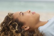Close-up of teenage girl day dreaming on beach — Stock Photo