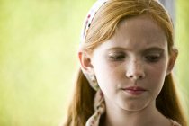 Portrait of sad ginger girl with freckles looking away — Stock Photo