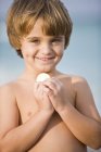Porträt eines lächelnden, hemdlosen kleinen Jungen mit Münze — Stockfoto