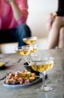 Close-up of glasses of champagne and cocktail snacks — Stock Photo