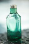 Close-up of empty bottle of aromatherapy oil — Stock Photo