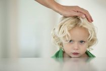 Close-up of human hand on blonde daughter head — Stock Photo