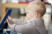 Close-up of cute blonde baby girl playing in room — Stock Photo
