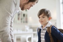 Man looking at son with schoolbag, closeup — Stock Photo