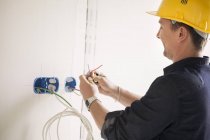 Close-up of male electrician working at site — Stock Photo