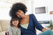 Portrait of a woman and her daughter smiling — Stock Photo
