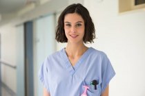 Ritratto di infermiera sorridente in piedi con le braccia incrociate — Foto stock