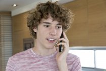 Мальчик-подросток разговаривает по мобильному телефону — стоковое фото