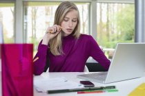 Young focused businesswoman working in office — Stock Photo