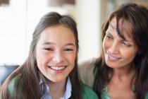 Portrait of a girl smiling with her mother — Stock Photo
