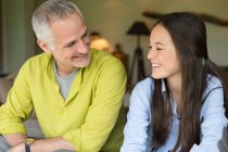 Man and his daughter smiling at home — Stock Photo
