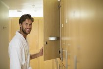 Portrait of man smiling in locker room of spa — Stock Photo