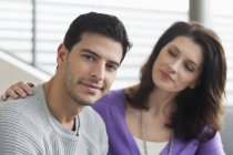 Portrait of smiling young man sitting with woman — Stock Photo