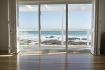 Sea view from glass door of coastal house — Stock Photo