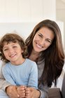 Portrait of a woman and her son smiling — Stock Photo