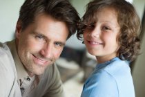 Portrait of a man with his son smiling — Stock Photo