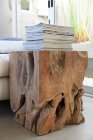 Stack of magazines on designed table made from tree stump — Stock Photo